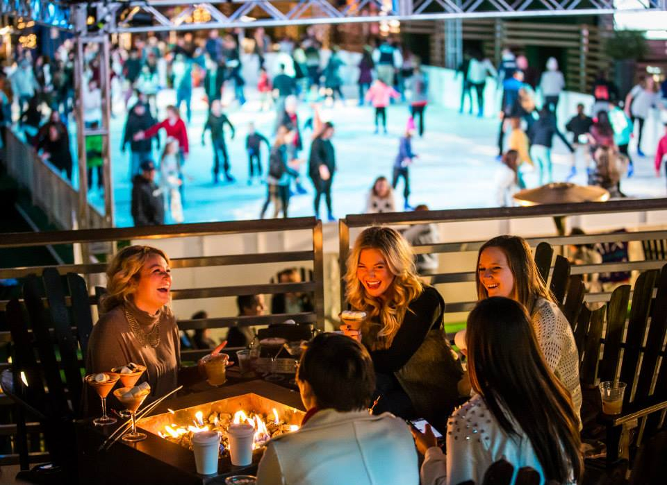 Guests enjoying fire pits beside The Ice Rink at The Cosmopolitan